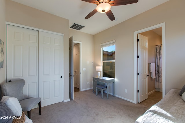 living area featuring light colored carpet and ceiling fan