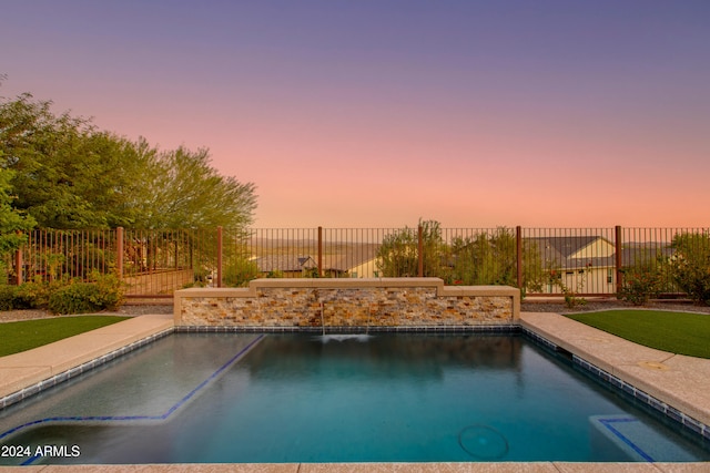 view of pool at dusk