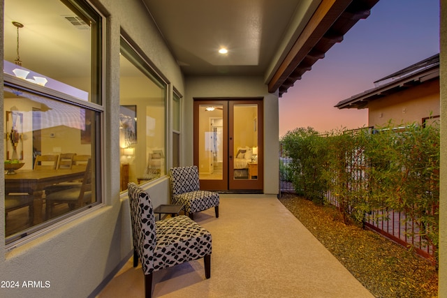 exterior entry at dusk with a patio area