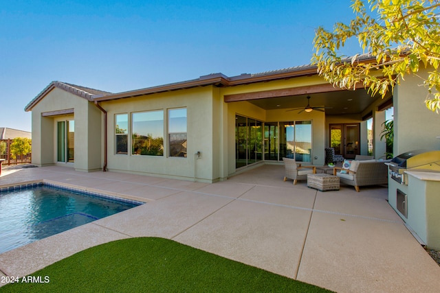 rear view of property with a patio, ceiling fan, and outdoor lounge area