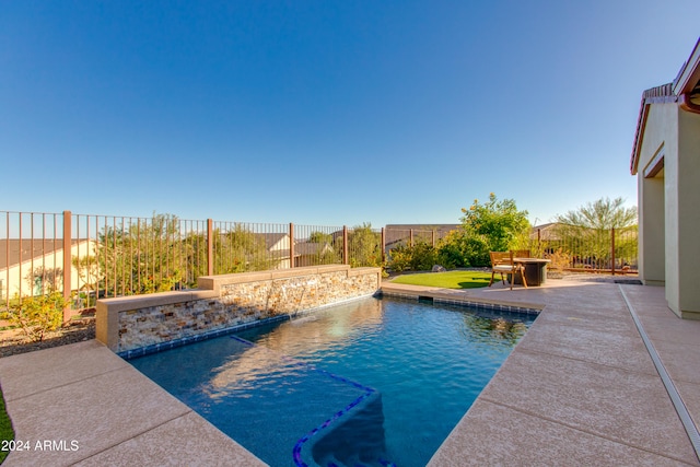 view of pool featuring pool water feature and a patio area