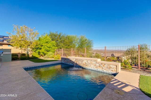 view of swimming pool featuring a patio and pool water feature