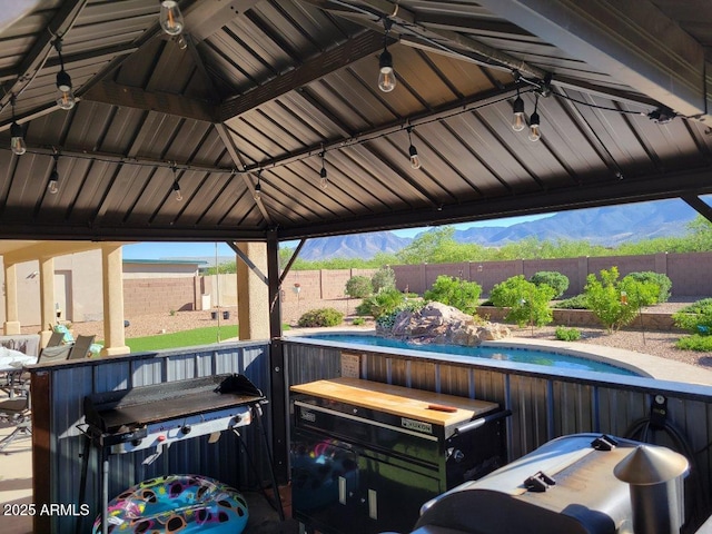 view of patio / terrace featuring a gazebo, a fenced in pool, and a fenced backyard