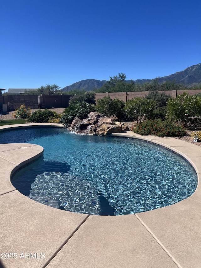 view of swimming pool with a mountain view, a fenced in pool, and fence private yard