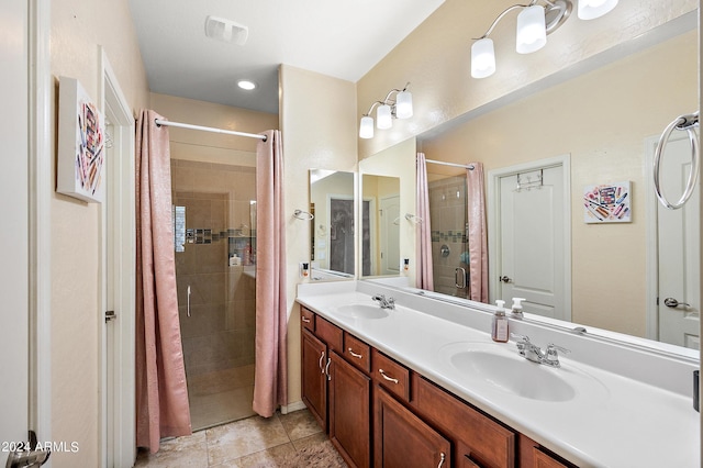 full bathroom featuring a stall shower, double vanity, a sink, and visible vents