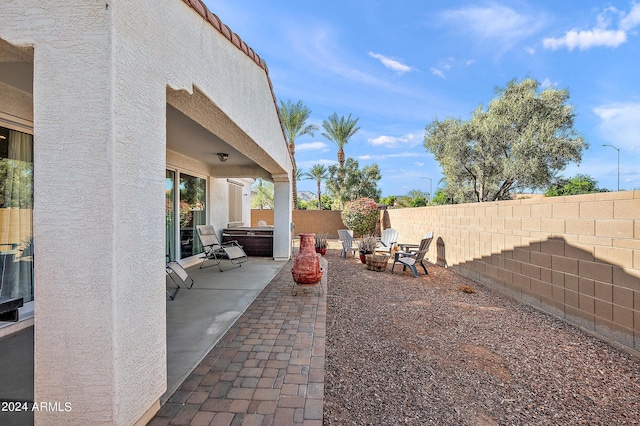 view of patio / terrace featuring a fenced backyard and a hot tub