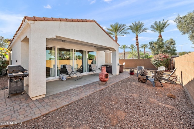 back of property with stucco siding, a patio, and a fenced backyard