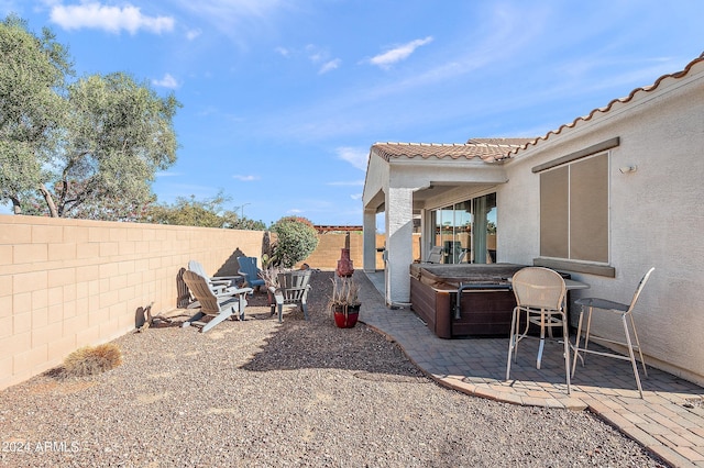 view of yard featuring a fenced backyard, a patio area, and a hot tub