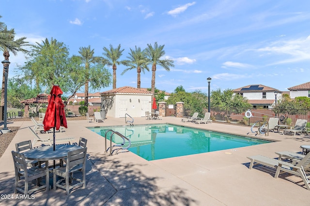 pool with fence and a patio area