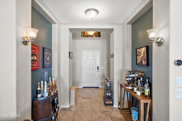 entryway featuring baseboards and light tile patterned floors