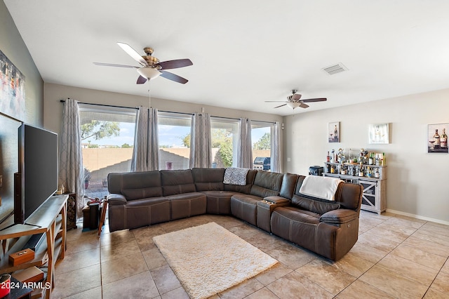 living room with a wealth of natural light, ceiling fan, light tile patterned floors, and visible vents