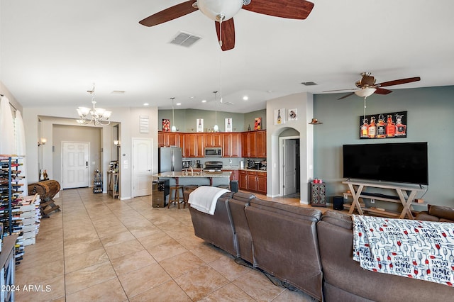 living room with light tile patterned floors, visible vents, recessed lighting, and ceiling fan with notable chandelier