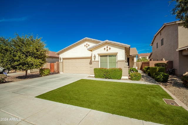 view of front of home with a front lawn and a garage