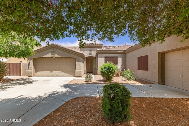 41804 W Carlisle Ln, Maricopa, AZ 85138 - mediterranean / spanish house with stucco siding, an attached garage, a tile roof, and driveway