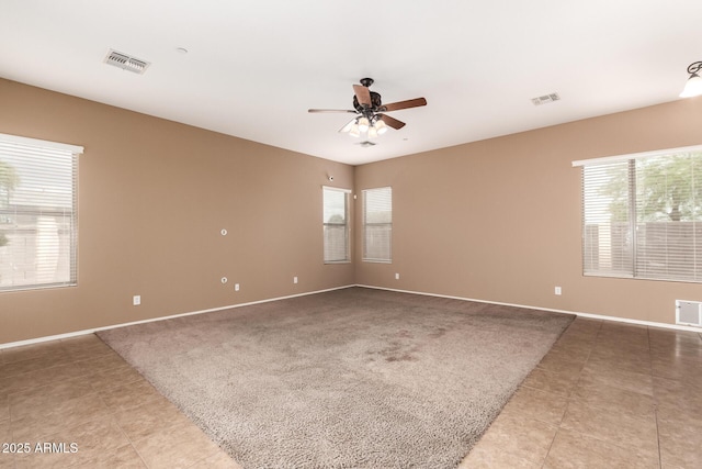41804 W Carlisle Ln, Maricopa, AZ 85138 - unfurnished room with plenty of natural light, a ceiling fan, and light tile patterned floors