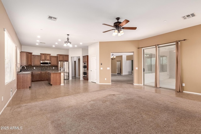 41804 W Carlisle Ln, Maricopa, AZ 85138 - unfurnished living room with a chandelier, a sink, baseboards, and recessed lighting