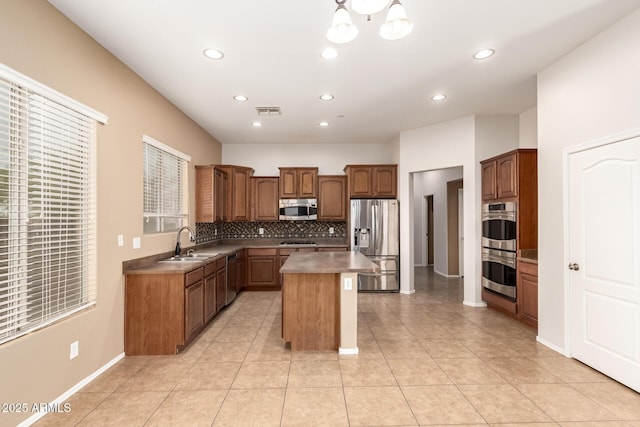 41804 W Carlisle Ln, Maricopa, AZ 85138 - kitchen featuring appliances with stainless steel finishes, a sink, decorative backsplash, a kitchen island, and recessed lighting