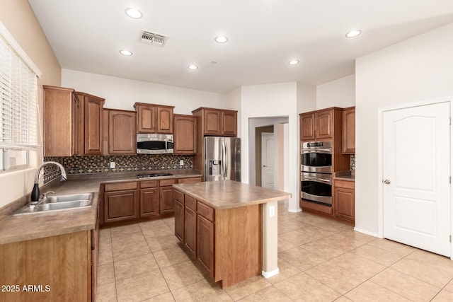 41804 W Carlisle Ln, Maricopa, AZ 85138 - kitchen with stainless steel appliances, a sink, decorative backsplash, a center island, and recessed lighting