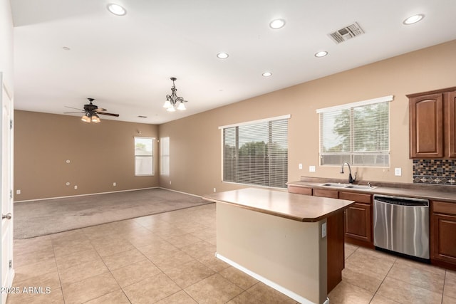 41804 W Carlisle Ln, Maricopa, AZ 85138 - kitchen with stainless steel dishwasher, light colored carpet, a sink, recessed lighting, and a kitchen island