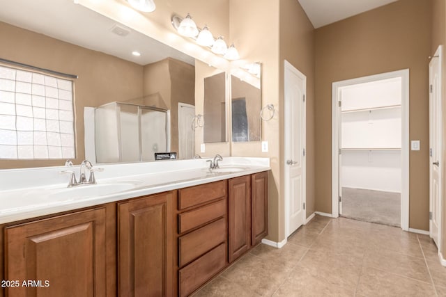 41804 W Carlisle Ln, Maricopa, AZ 85138 - full bath with an enclosed shower, double vanity, baseboards, tile patterned flooring, and a walk in closet