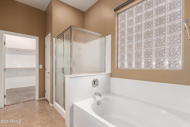 41804 W Carlisle Ln, Maricopa, AZ 85138 - bathroom featuring a stall shower, a spacious closet, a garden tub, and tile patterned floors