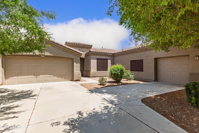 41804 W Carlisle Ln, Maricopa, AZ 85138 - mediterranean / spanish house with concrete driveway, stucco siding, a tiled roof, and an attached garage