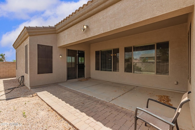 41804 W Carlisle Ln, Maricopa, AZ 85138 - back of property featuring stucco siding, a tiled roof, fence, and a patio area