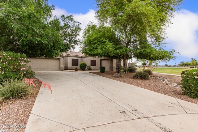 41804 W Carlisle Ln, Maricopa, AZ 85138 - view of front of home featuring stucco siding, concrete driveway, and a tiled roof