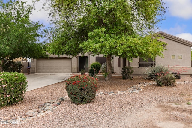 41804 W Carlisle Ln, Maricopa, AZ 85138 - obstructed view of property featuring concrete driveway, stucco siding, and a garage