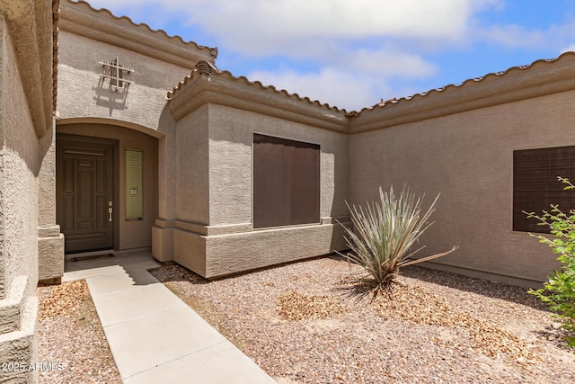 41804 W Carlisle Ln, Maricopa, AZ 85138 - view of exterior entry featuring stucco siding and a tile roof