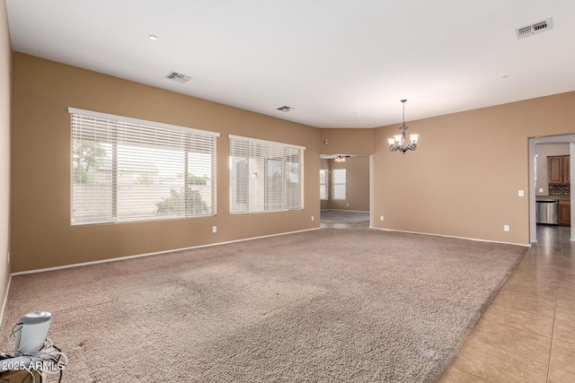 41804 W Carlisle Ln, Maricopa, AZ 85138 - unfurnished room with a chandelier, baseboards, light tile patterned floors, and light carpet