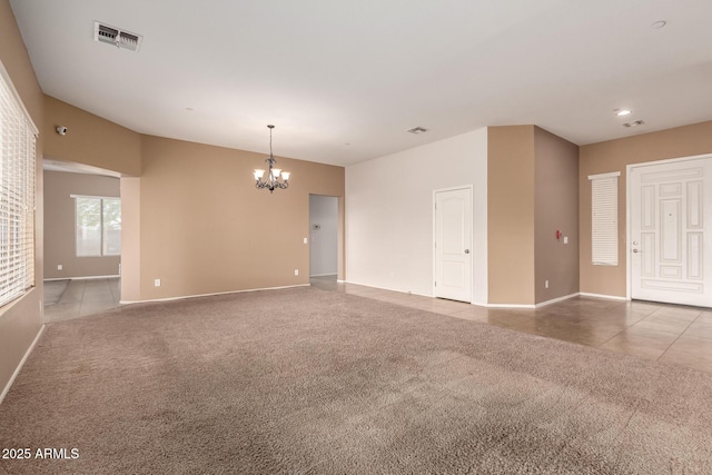 41804 W Carlisle Ln, Maricopa, AZ 85138 - carpeted spare room with a chandelier, baseboards, and tile patterned flooring