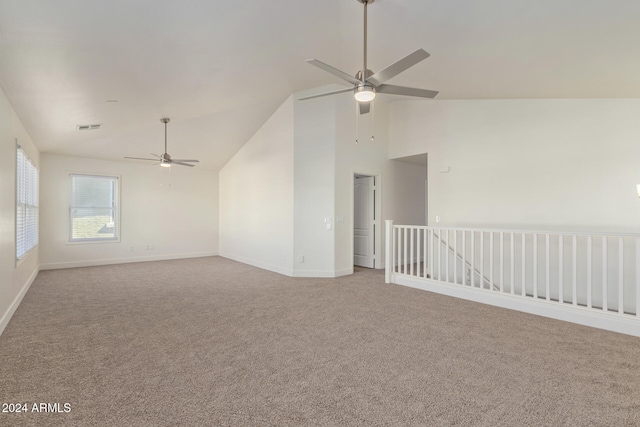 carpeted spare room with ceiling fan and lofted ceiling