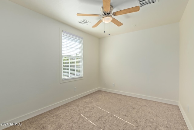 carpeted empty room featuring ceiling fan