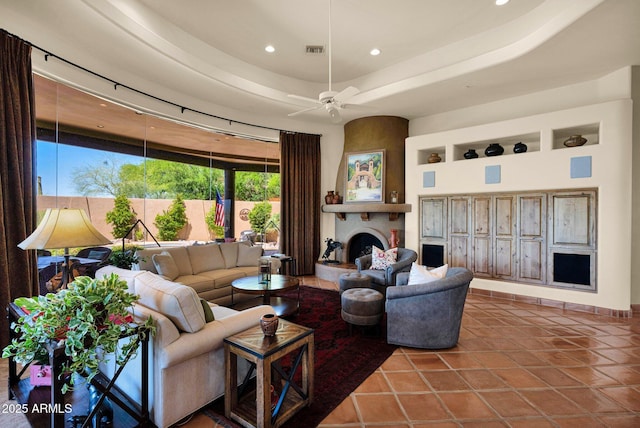 8154 E Tecolote Cir, Scottsdale, AZ 85266 - tiled living area featuring recessed lighting, a ceiling fan, a large fireplace, and a raised ceiling