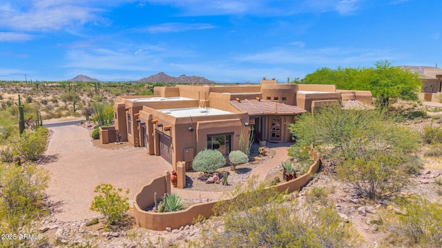 8154 E Tecolote Cir, Scottsdale, AZ 85266 - view of front of property with a garage, stucco siding, a mountain view, and driveway