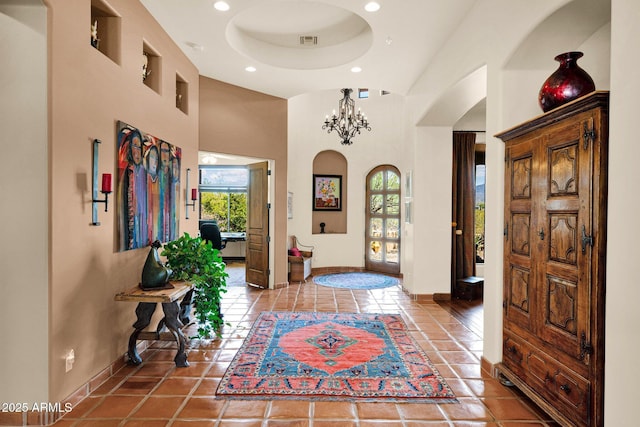8154 E Tecolote Cir, Scottsdale, AZ 85266 - tiled entryway with a towering ceiling, arched walkways, recessed lighting, and a chandelier