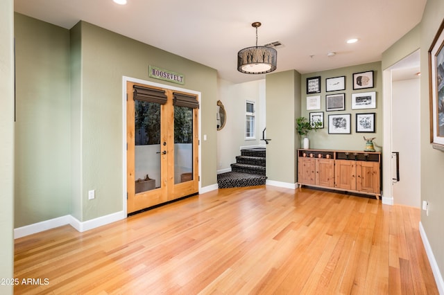 interior space with wood-type flooring and french doors