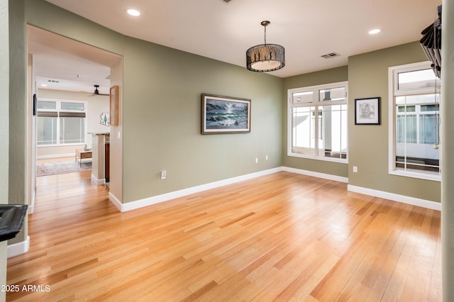 spare room featuring ceiling fan and light hardwood / wood-style floors