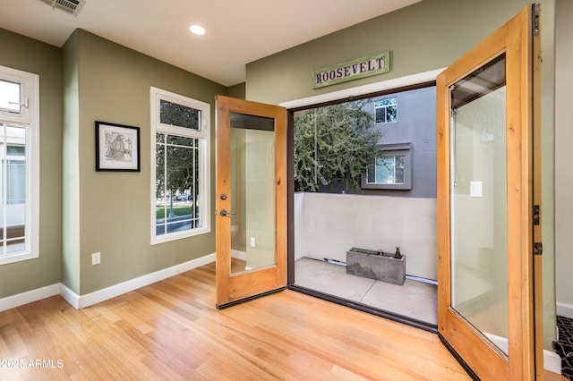 entryway with light hardwood / wood-style flooring and french doors