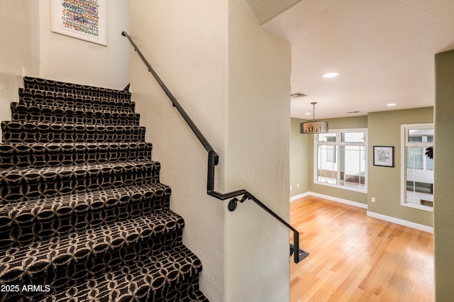 stairs featuring wood-type flooring