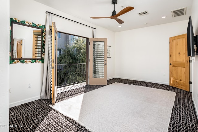 interior space featuring ceiling fan and dark colored carpet