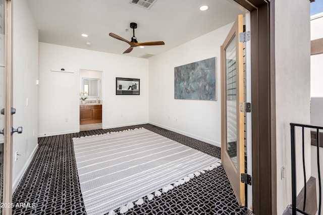 bedroom with dark carpet, ensuite bath, french doors, and ceiling fan