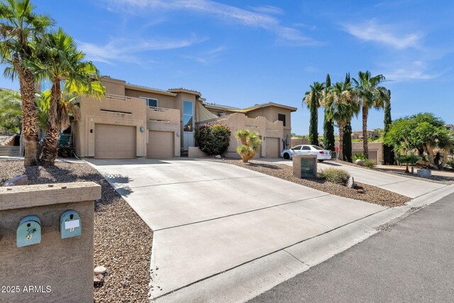 12852 N Mountainside Dr Unit 2, Fountain Hills, AZ 85268 - view of front facade featuring stucco siding, concrete driveway, an attached garage, a balcony, and a residential view