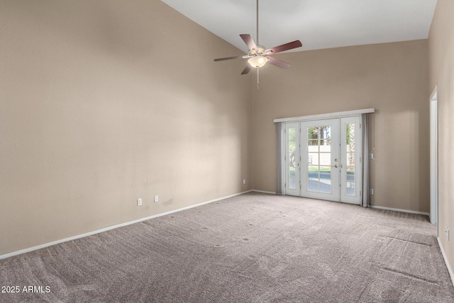 carpeted spare room with ceiling fan, high vaulted ceiling, and french doors