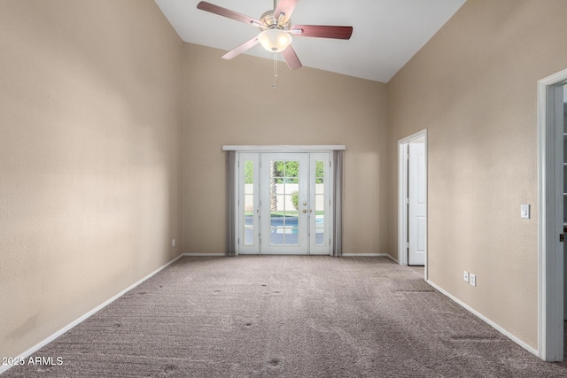 carpeted empty room featuring french doors, vaulted ceiling, and ceiling fan