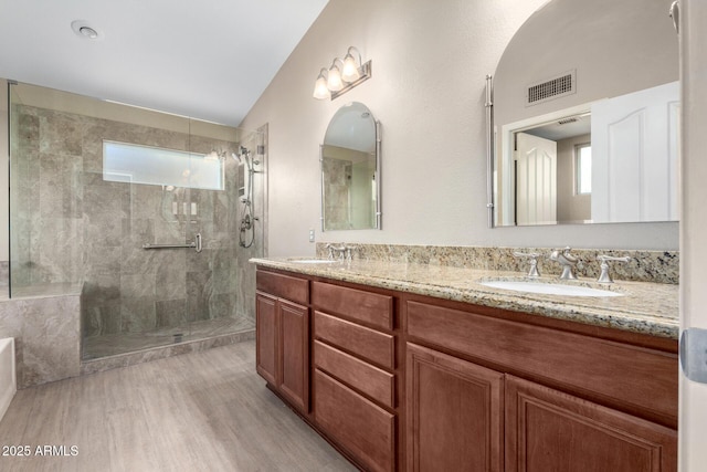 bathroom featuring vanity, wood-type flooring, and an enclosed shower