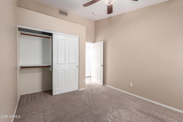 unfurnished bedroom featuring ceiling fan, a closet, and carpet