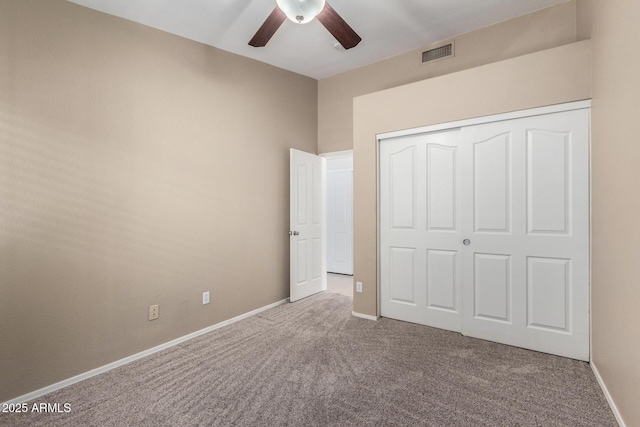 unfurnished bedroom with carpet flooring, a closet, and ceiling fan