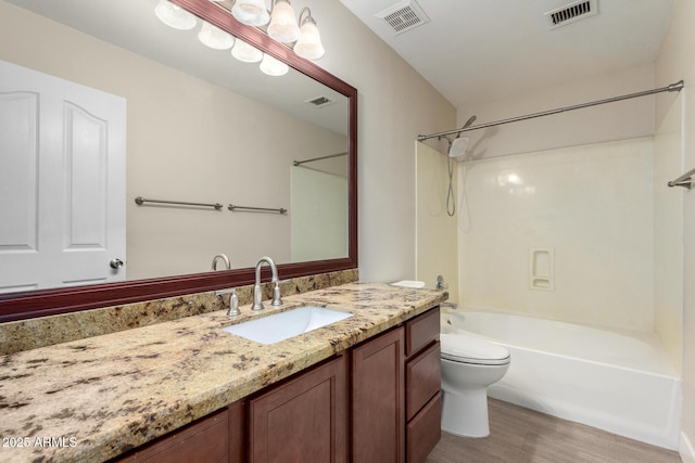 full bathroom with hardwood / wood-style floors, vanity,  shower combination, and toilet